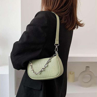 woman green croc embossed handbags